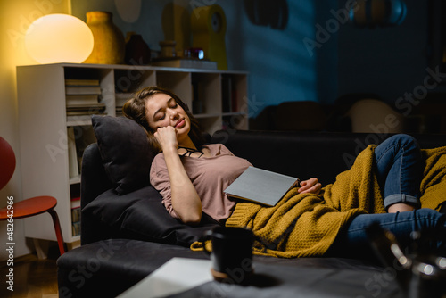 woman fell asleep while reading a book at home