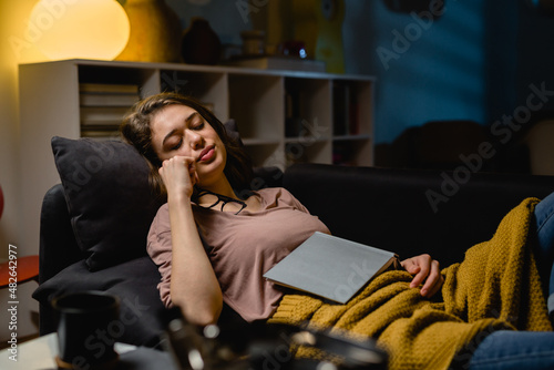 woman fell asleep while reading a book at home