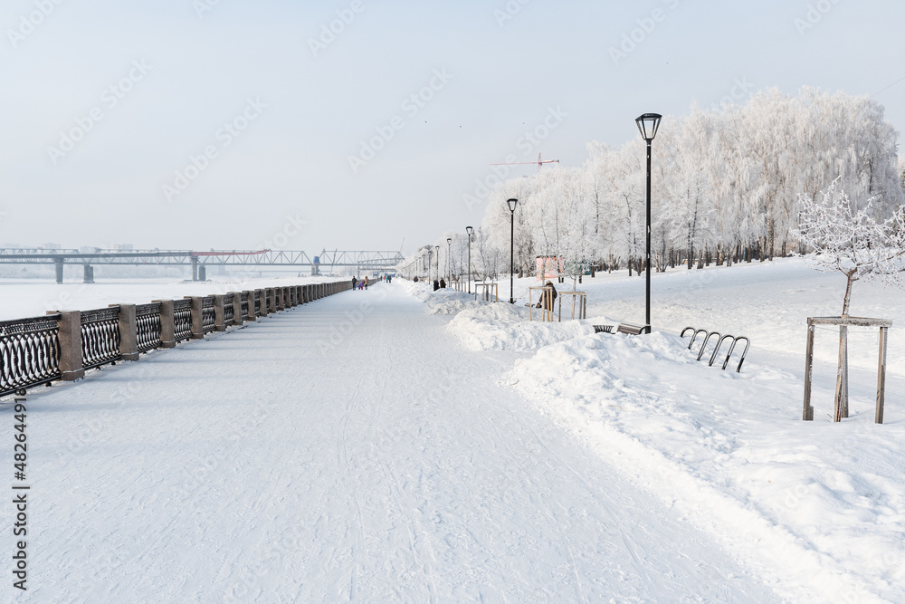 Beautiful city landscape in snowy winter. Novosibirsk embankment Beautiful city landscape in snowy winter. Novosibirsk embankment