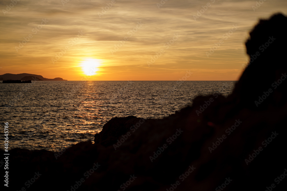 Cala Viola de Ponent, Menorca. September 2021. Magnificent sunset in the Mediterranean Sea. On one of the paradisaical beaches of the island of Menorca.