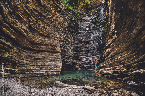 Girl Taking Natural Shower on Waterfall photo