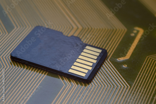 the black micro sd card lies on the microcircuit. close-up.