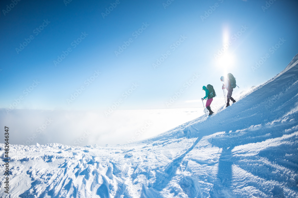 climbers on the top of the mountain in winter