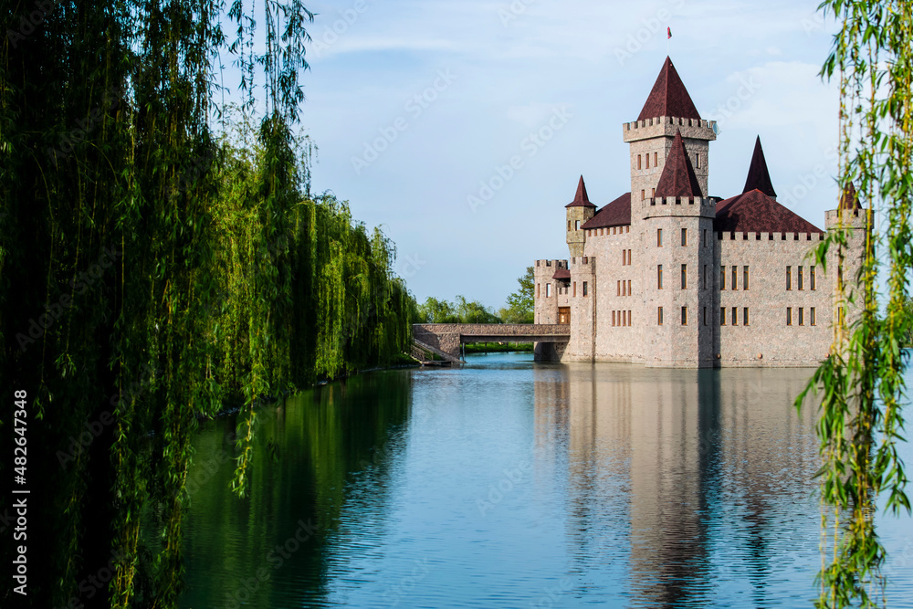 The castle stands on a blooming green lake, surrounded by a beautiful park area. The castle stands on a blooming green lake, surrounded by a beautiful park area.