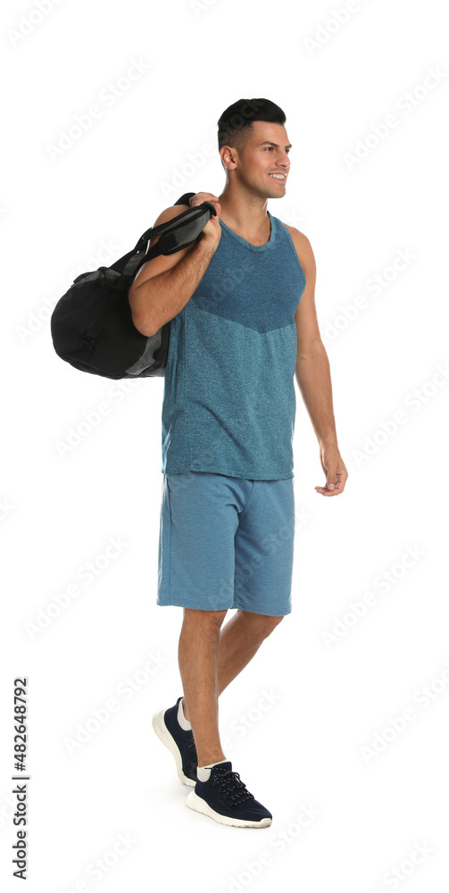 Fototapeta premium Handsome man with sports bag on white background