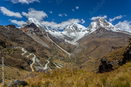 Panoramic image of a road crossing the highest part of the Andes mountain range, with the Huascaran mountain in the background, in Ancash, Peru