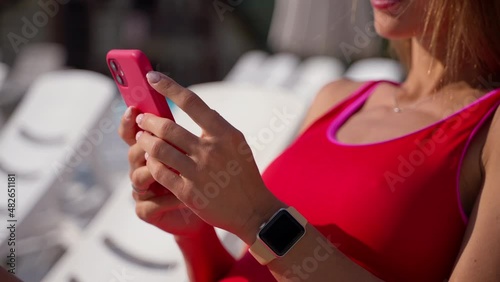 Girl vacationer sunbathing and using phone