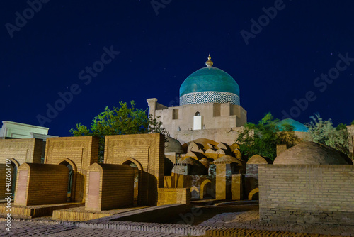 Night view of the Pahlavan Mahmud mausoleum and the adjacent old Muslim cemetery. Shot in Khiva, Uzbekistan photo