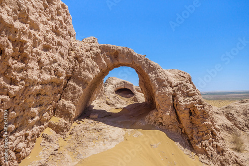 Walls of ancient fortress Ayaz-Kala in Kyzylkum desert, Uzbekistan. Walls had 2 levels, lower arched passage of lower part is visible here. Fortifications were built in 3-4th century BC photo