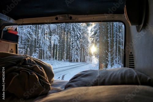 View out of a campervan into a snowy forest