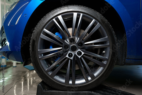 Front wheel of modern blue sport car © fotofabrika