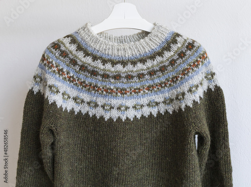 Brown and grey Icelandic wool knitted lopapeysa sweater in traditional nordic pattern, close up yoke view