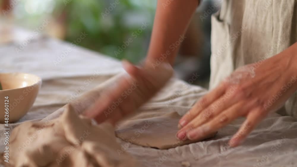Female hands sculpting something of clay at home Female hands sculpting something of clay at home