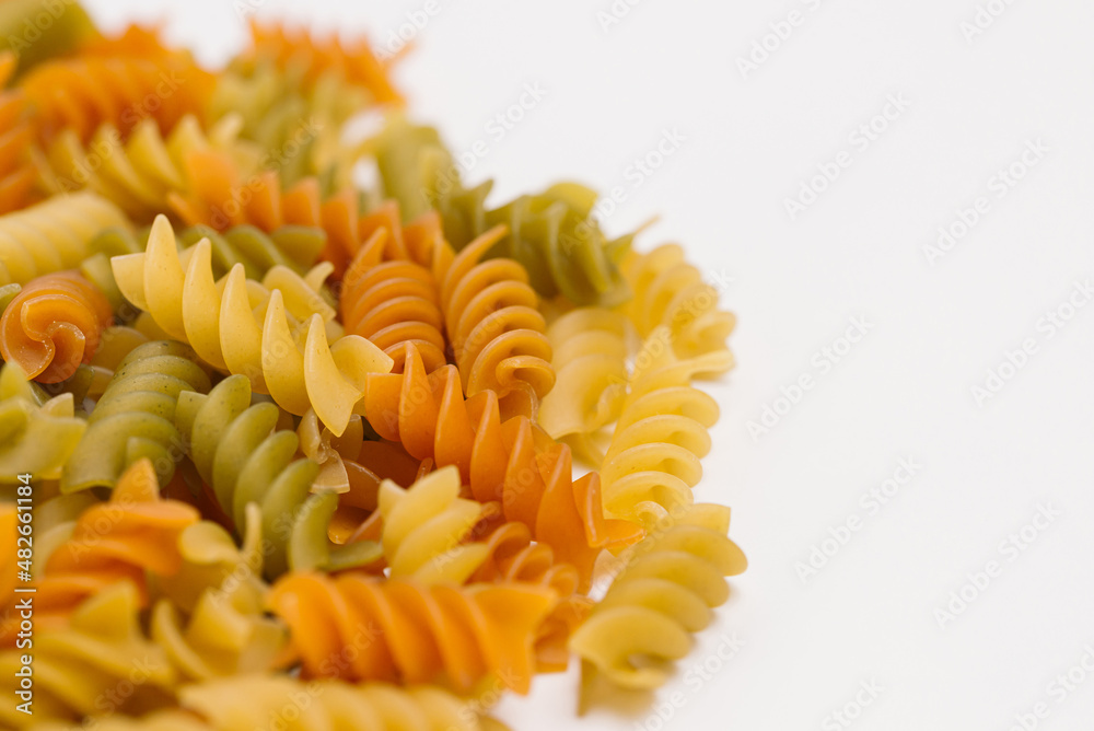Italian twisted colored pasta on white background. Three Colors Rotini or Fusilli Pasta. Italian twisted colored pasta on white background. Three Colors Rotini or Fusilli Pasta.
