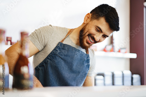 Quadro su tela Portrait of confident young salesman standing in butcher's shop