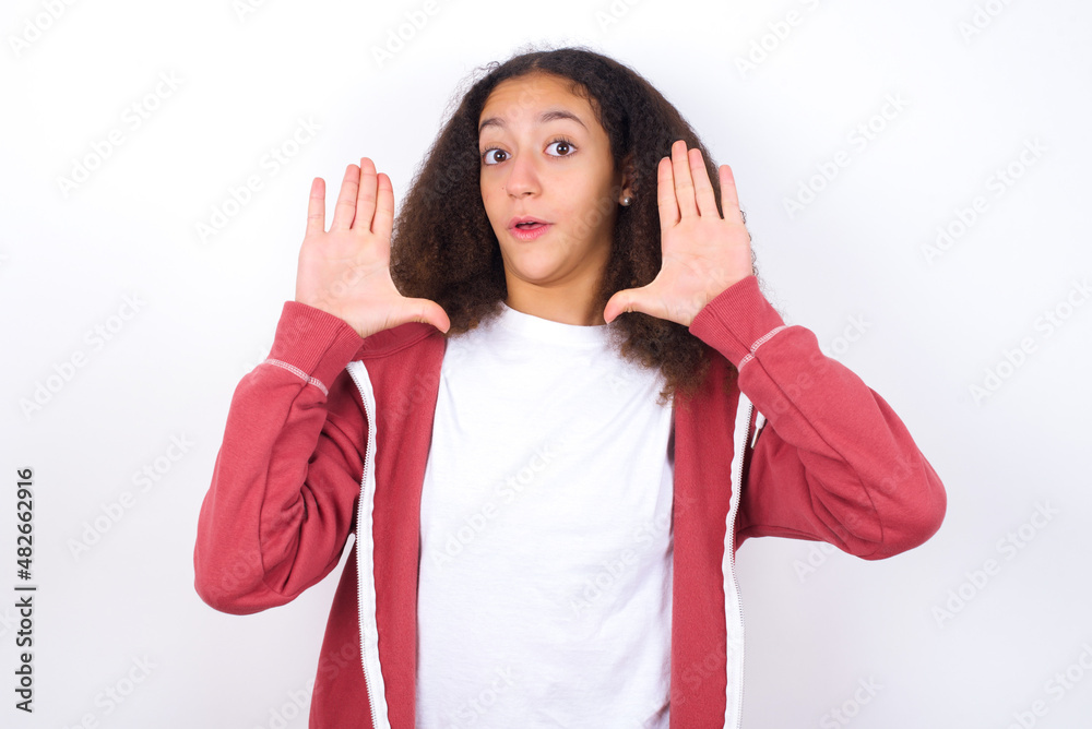 teenager girl wearing pink jacket standing against wite background Moving away hands palms showing refusal and denial with afraid and disgusting expression. Stop and forbidden. teenager girl wearing pink jacket standing against wite background Moving away hands palms showing refusal and denial with afraid and disgusting expression. Stop and forbidden.