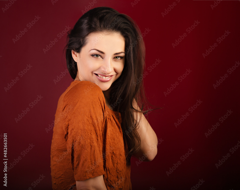 Beautiful happy smiling woman on dark red background with empty copy space. Closeup front view portrait of natural female. Valentine's Day Beautiful happy smiling woman on dark red background with empty copy space. Closeup front view portrait of natural female. Valentine's Day