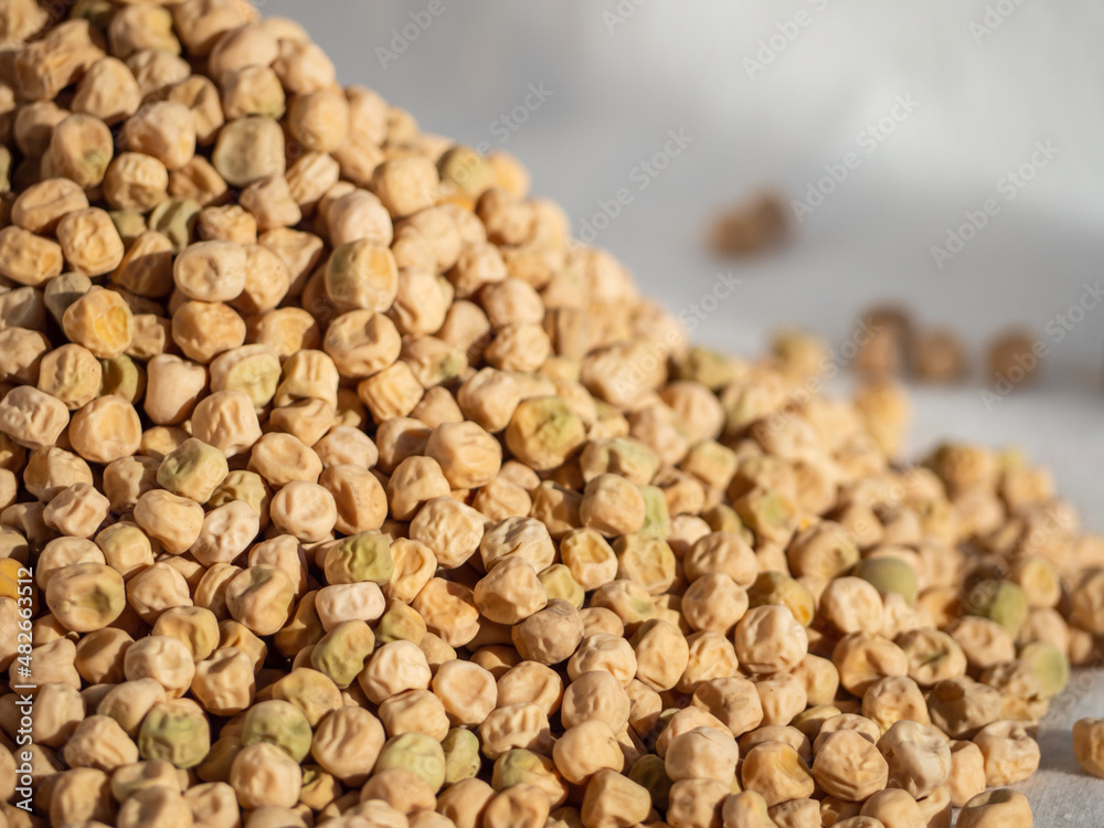 A mound of dry green peas. Close-up of textured peas. Shallow depth of field, space for insertion or text A mound of dry green peas. Close-up of textured peas. Shallow depth of field, space for insertion or text