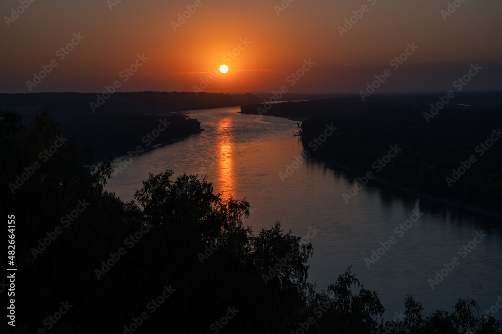 View of river landscape in sunny summer sunset. Top view of siberian Ob river from high attitude in summer sunset.