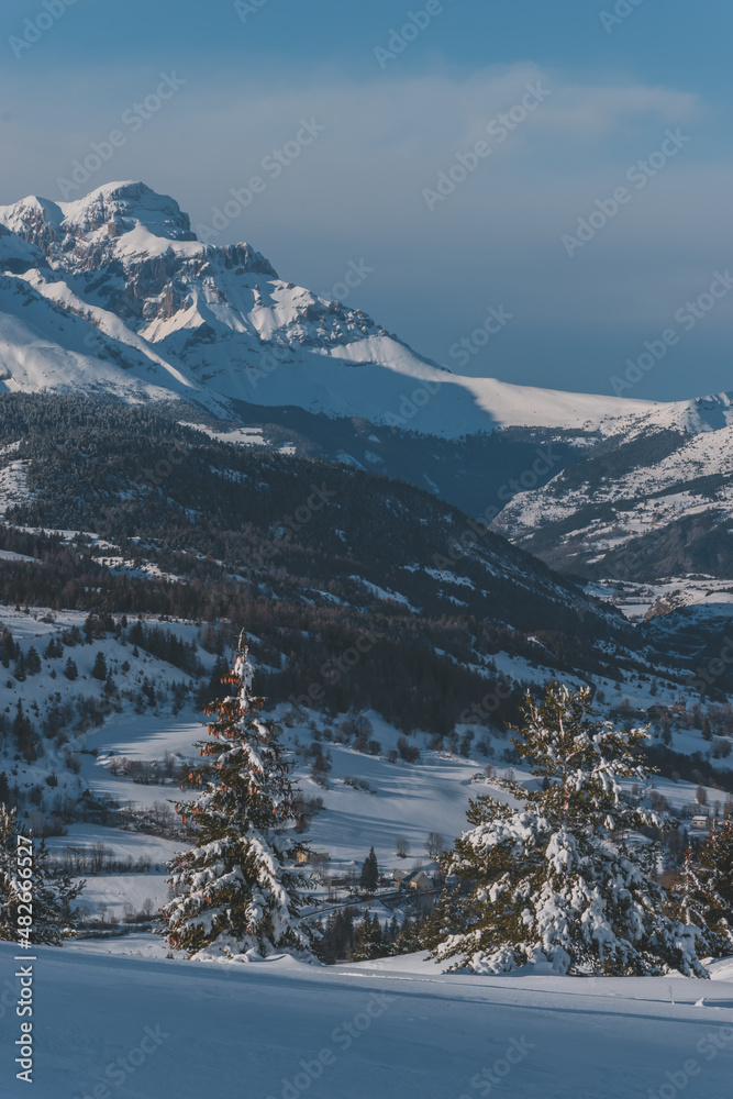 A picturesque vertical landscape view of the French Alps mountains on a cold winter day (Hautes-Alpes, Devoluy valley)