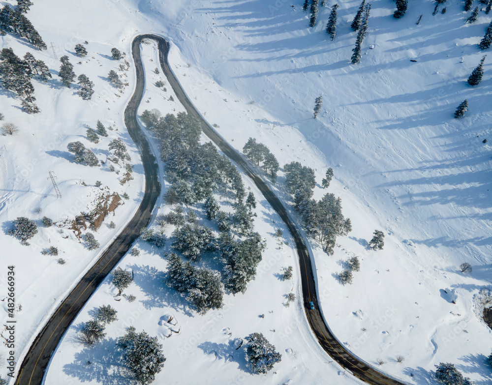 Aerial view on the road and forest at the winter time. Natural winter landscape from air. Landscape from drone.TURKEY