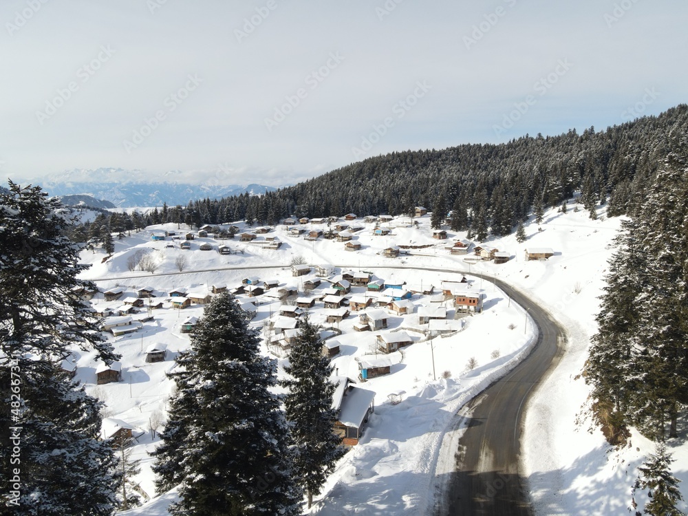 Aerial view on the road and forest at the winter time. Natural winter landscape from air. Landscape from drone.TURKEY