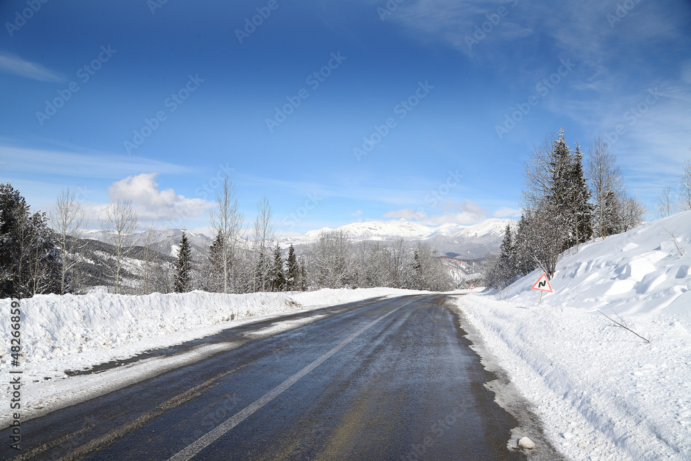 Curved asphalt road in a forest covered with snow in.turkey Curved asphalt road in a forest covered with snow in.turkey