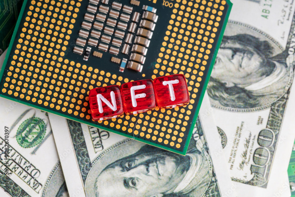 Obraz premium nft letters on red cubes on the background of dollars