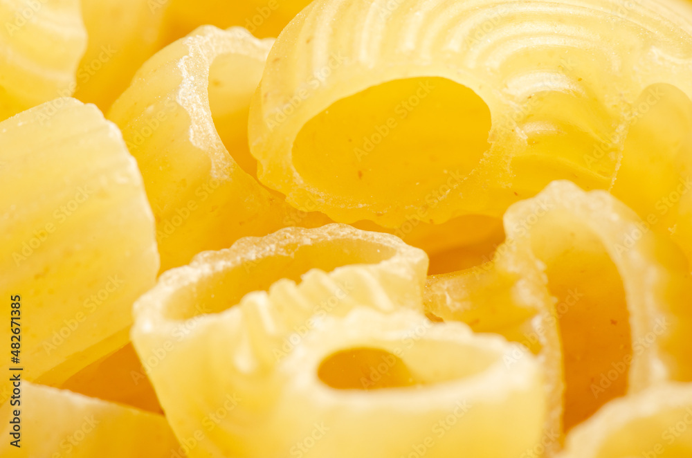 Raw ziti pasta. Food background. An ingredient for traditional Italian food. Closeup Raw ziti pasta. Food background. An ingredient for traditional Italian food. Closeup