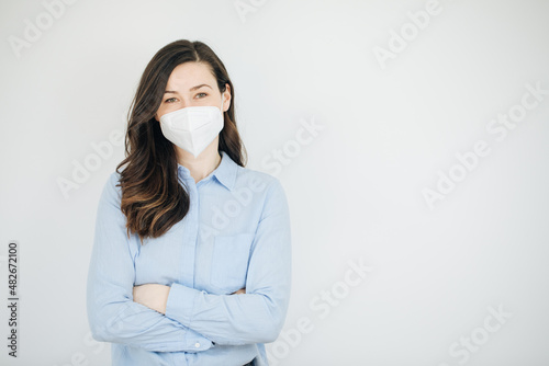 woman with flu mask. woman wearing a ffp2 protective mask. Cheerful business woman or teacher shows her ffp2 protective mask. Wearing mask in office. Person takes off the protective mask 