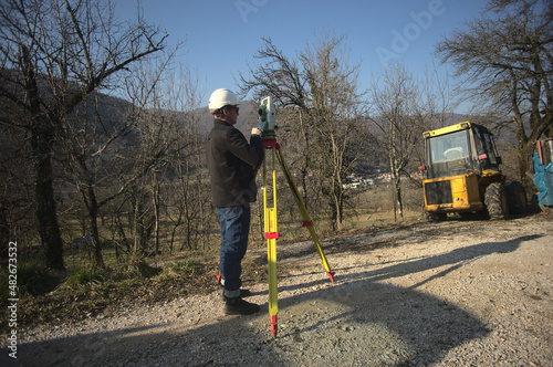 surveyor engineer measuring filds