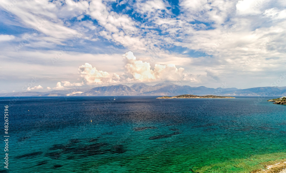 Obraz premium White clouds on blue sky or azure sky background, over mountain ranges and turquoise sea. Seacape