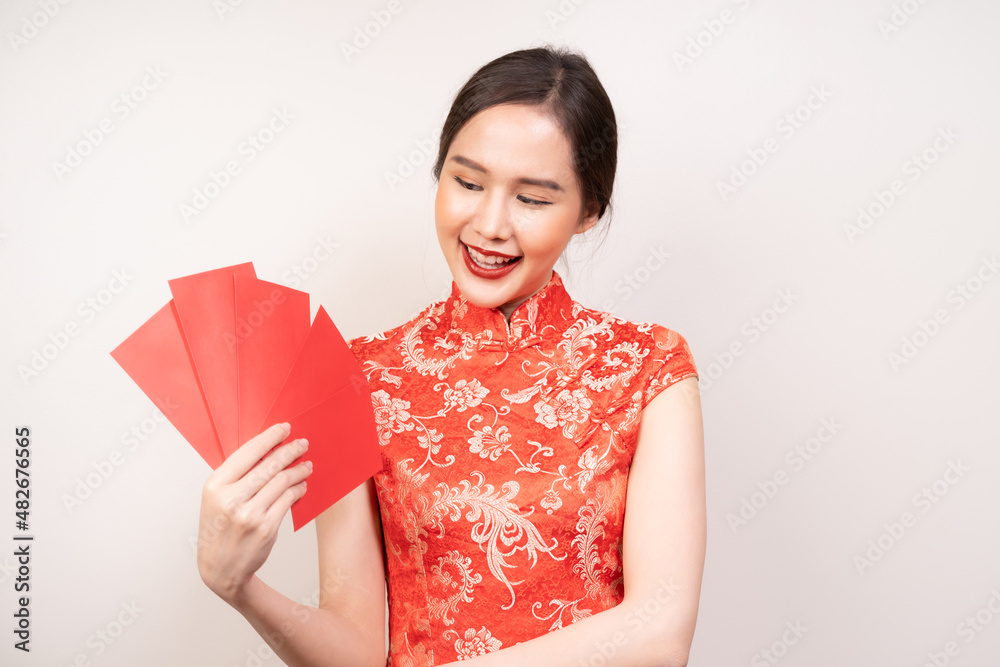 Chinese new year festival celebrate culture of china people, cheerful asian young woman, girl hand holding red envelope, ang pao ,wearing red cheongsam dress traditional. Isolated on white background. Chinese new year festival celebrate culture of china people, cheerful asian young woman, girl hand holding red envelope, ang pao ,wearing red cheongsam dress traditional. Isolated on white background.