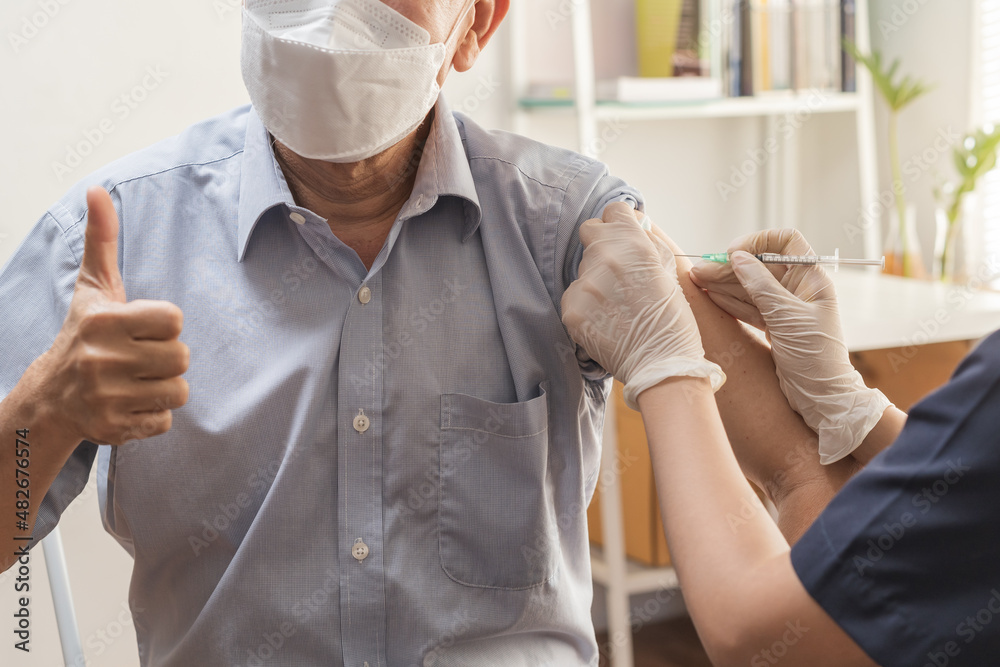 Covid-19,coronavirus, elderly asian adult man getting vaccine from doctor or nurse giving shot to mature patient at clinic. Healthcare, immunization, disease prevention against flu or virus pandemic. Covid-19,coronavirus, elderly asian adult man getting vaccine from doctor or nurse giving shot to mature patient at clinic. Healthcare, immunization, disease prevention against flu or virus pandemic.