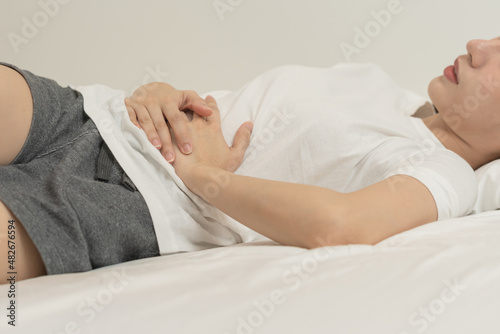 Photos Flatulence ulcer, asian young woman, girl hands in belly, stomachache from food poisoning, abdominal pain and digestive problem, gastritis or diarrhoea