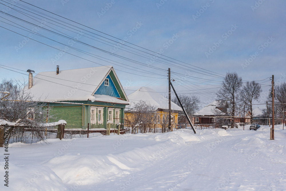Street with wooden old houses in winter