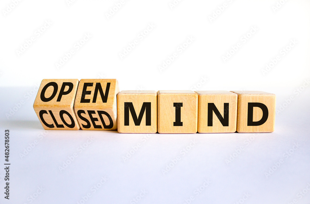 Open or closed mind symbol. Turned wooden cubes and changed concept words closrd mind to open mind. Beautiful white table, white background, copy space. Business open or closed mind concept. Open or closed mind symbol. Turned wooden cubes and changed concept words closrd mind to open mind. Beautiful white table, white background, copy space. Business open or closed mind concept.