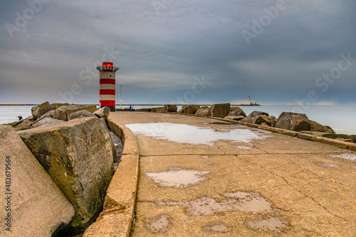 Concrete jetty near IJmuiden with anglers photo