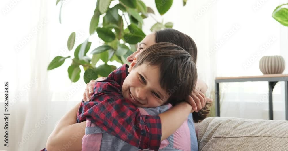 Happy mother greeting and embracing son on his arrival at home Happy mother greeting and embracing son on his arrival at home
