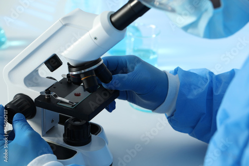 Scientist working with microscope at table, closeup. Medical research