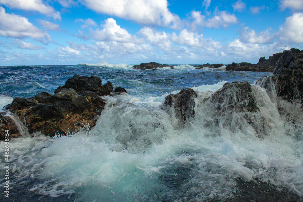 Waves hitting the rocks. Rocky cliffs on sea, seascape.