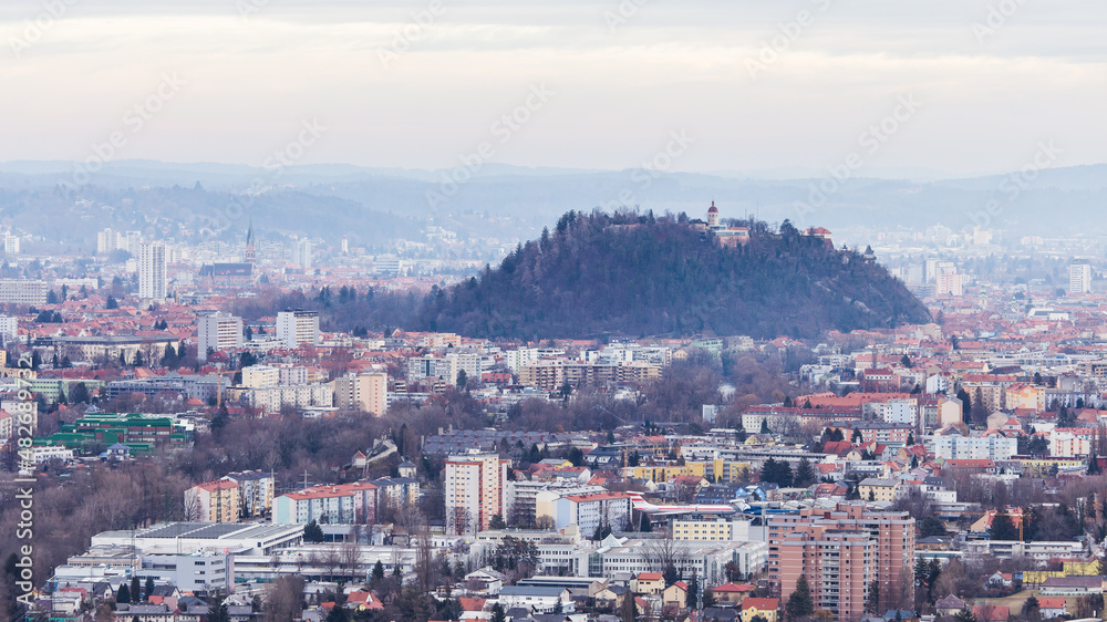 Aerial view of Graz in Austria on a depressive and foggy winter day with lots of fine dust and smog in the air