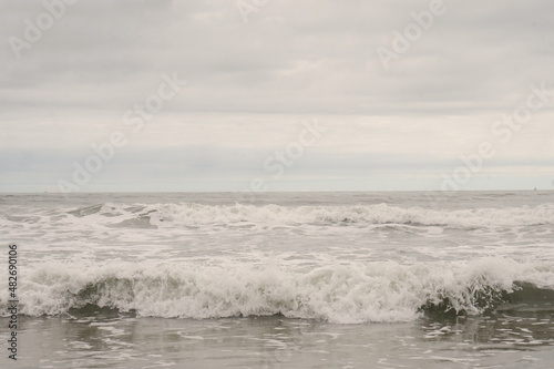 Waves at Cape May New Jersey Beach with Blue Sky and White Clouds