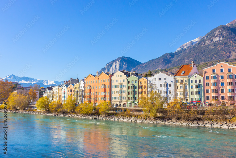 Innsbruck, Austria - 11.21.2021: Historical centre of Innsbruck. Innsbuck landmark. River embankment in Tirol. Winter landscape with Austrian Alps. Sunny day in Alps, Tyrol. 