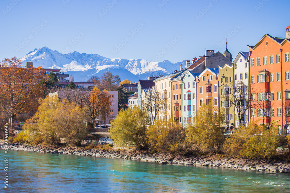 Fototapeta premium Innsbruck, Austria - 11.21.2021: Historical centre of Innsbruck. Innsbuck landmark. River embankment in Tirol. Winter landscape with Austrian Alps. Sunny day in Alps, Tyrol. 