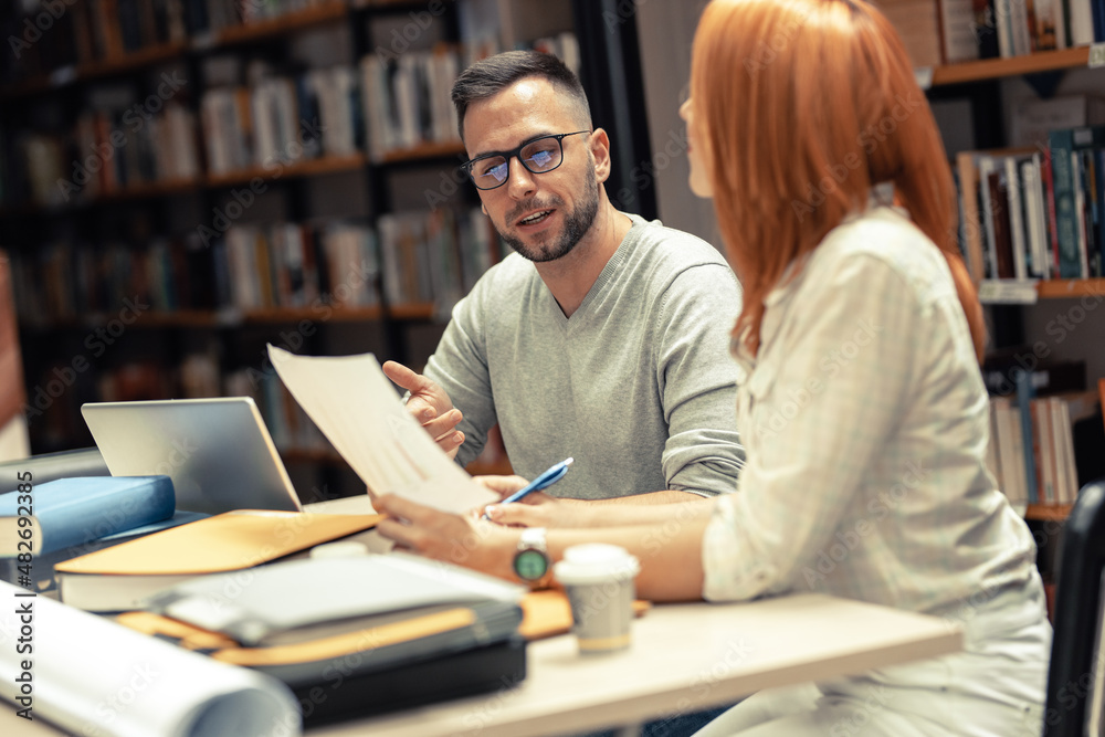 Two students study in the campus library.
Two students study in the campus library.