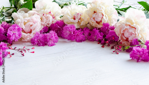 Beautiful frame with white flowers and bright carnations for invitation, text with place to visit