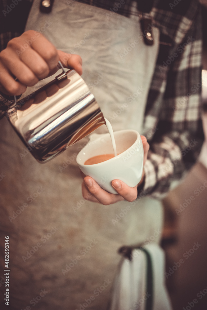 Barista pouring latte art