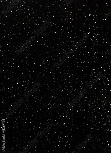 white raindrops on the window against the background of the night sky
