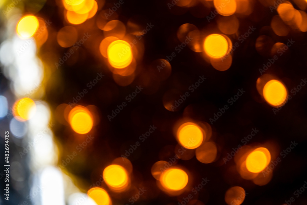 Obraz premium Romantic golden abstract bokeh with black background